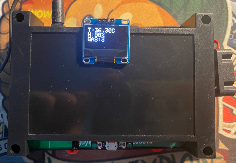 A black rectangular device with a small display

Description automatically generated